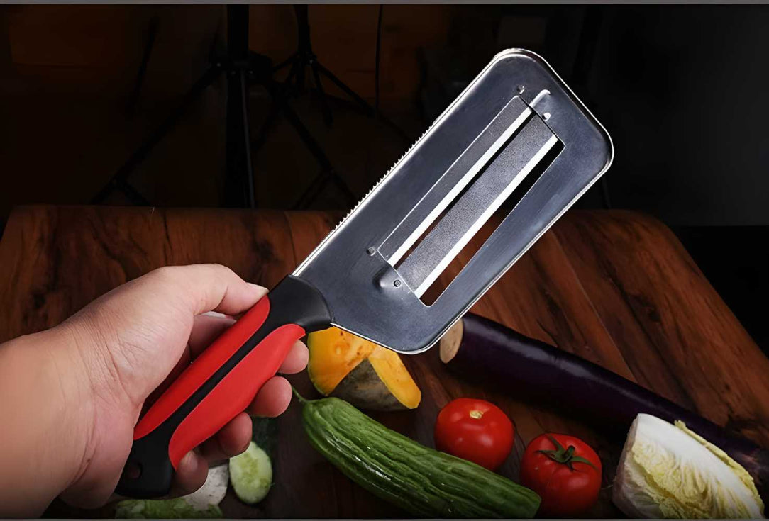 Hand holding a vegetable peeler with vegetables on a wooden surface