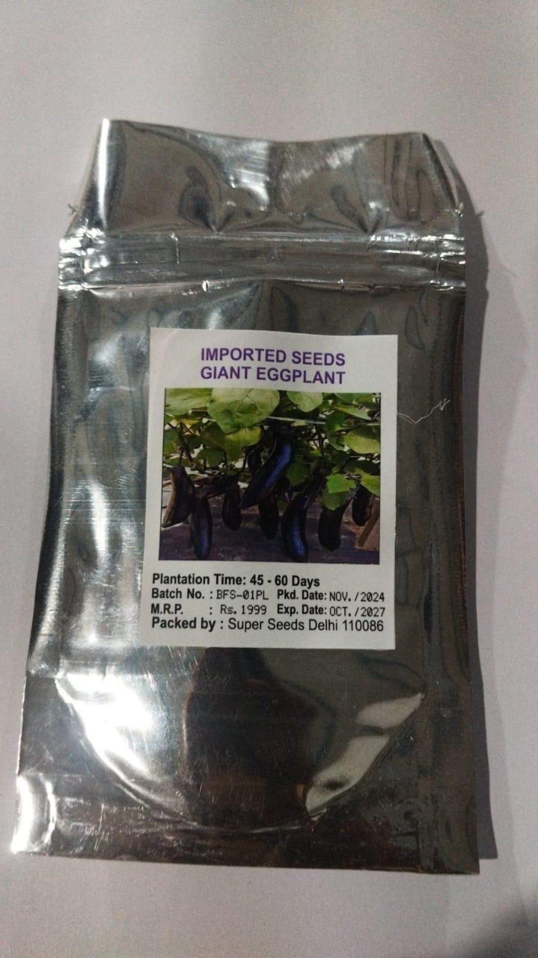 Package of imported giant eggplant seeds with a label on a white background