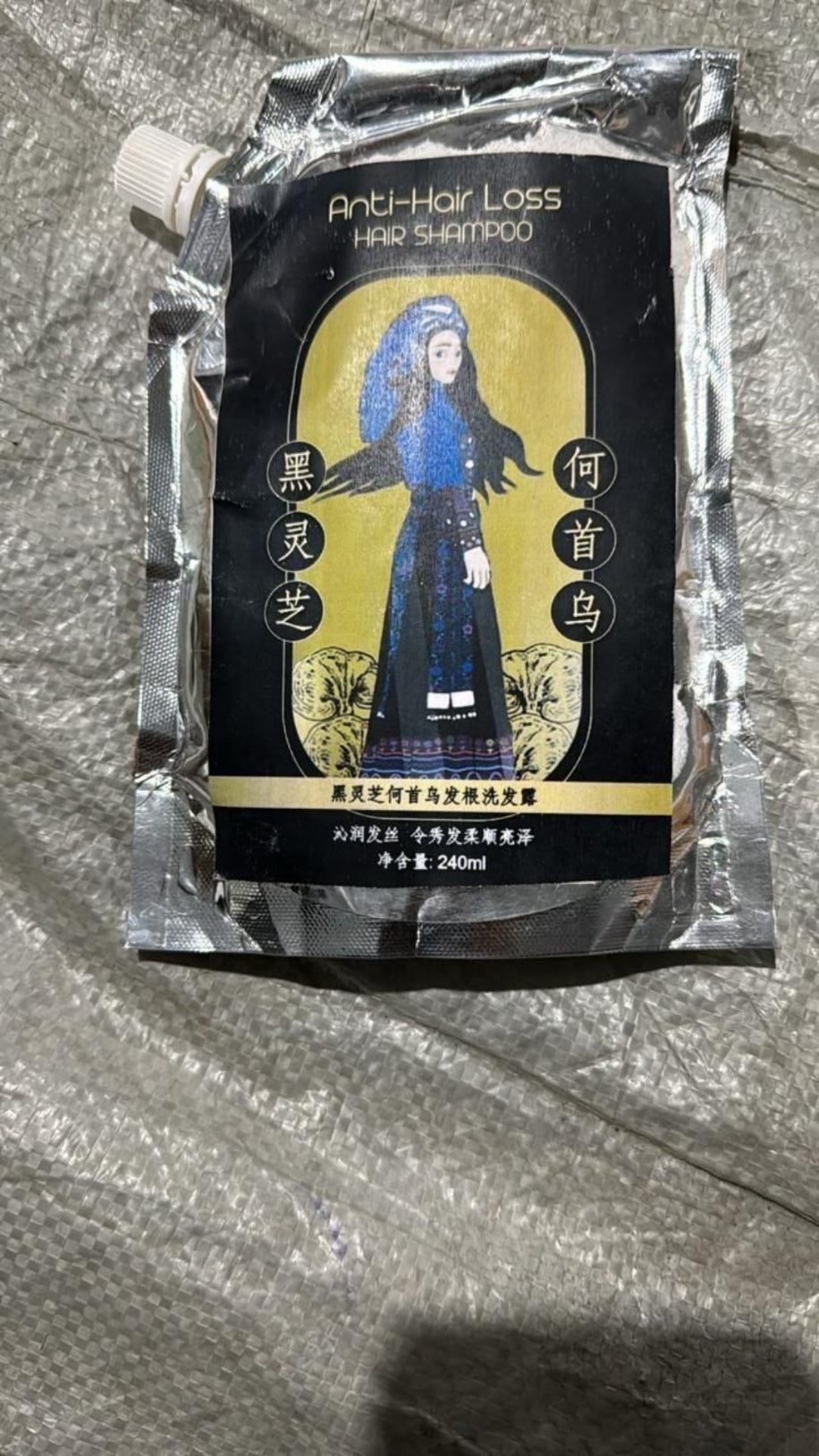 Shampoo packaging with a character illustration on a reflective surface