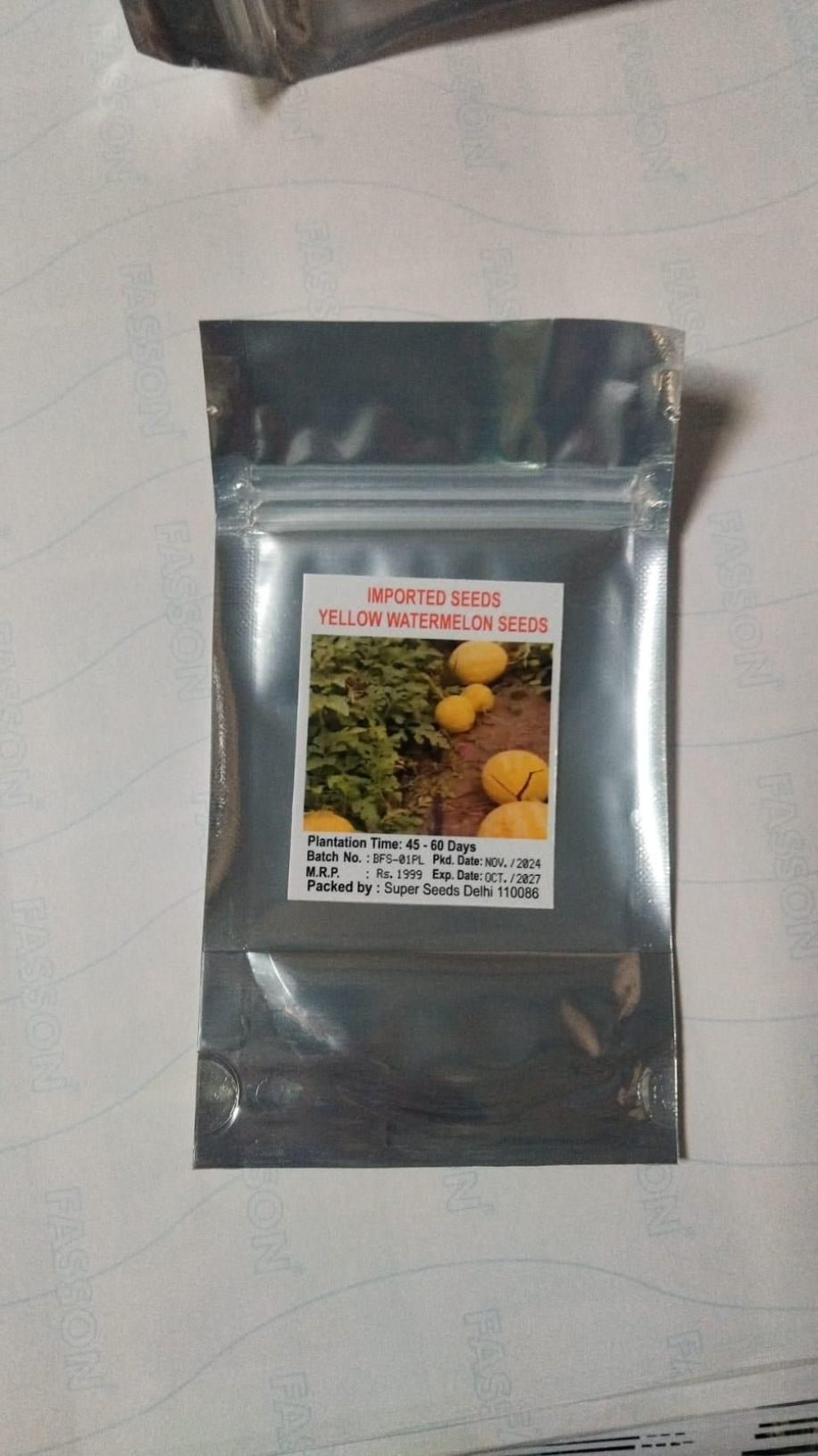 Seed packet for yellow watermelon seeds on a white background