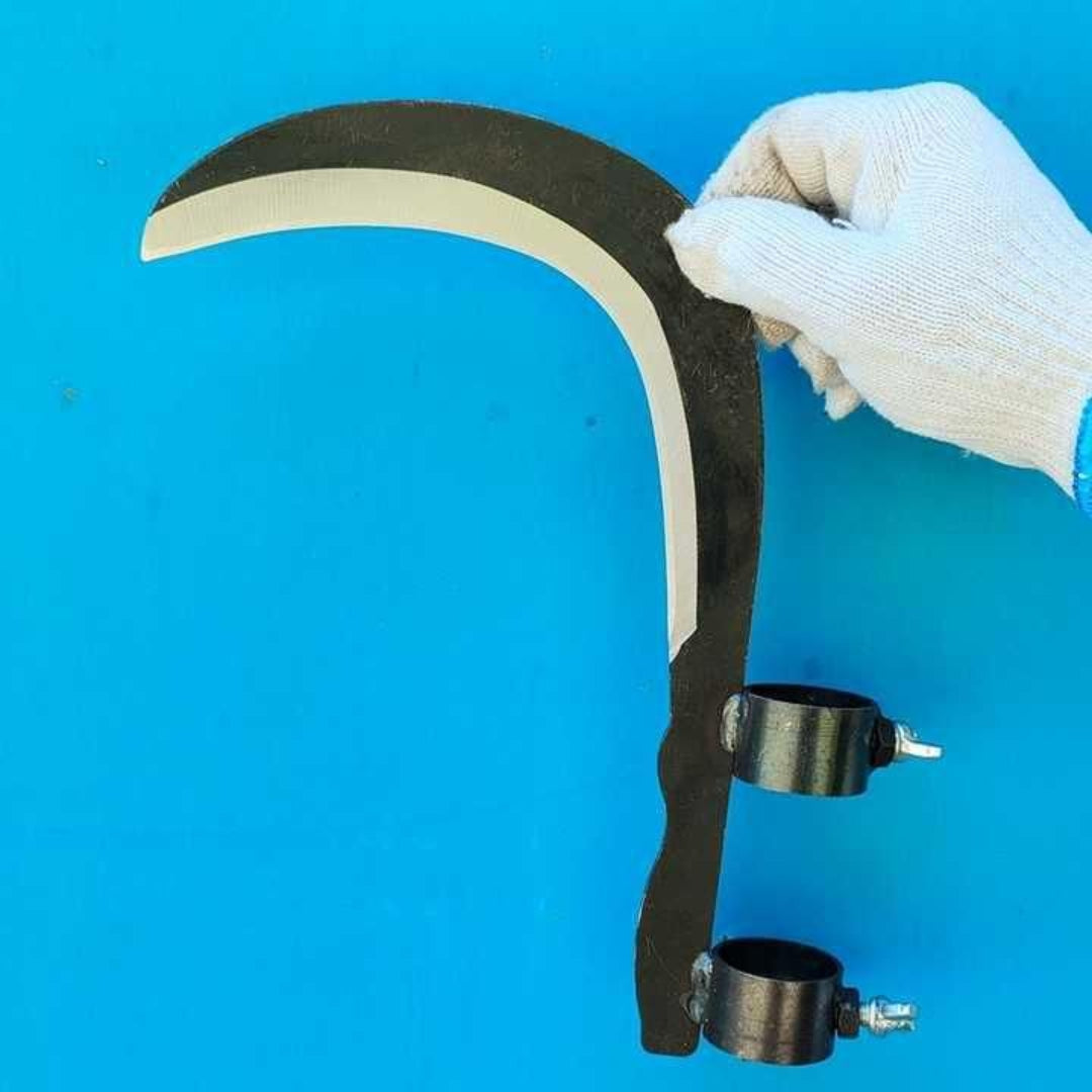Hand holding a large tool with a curved blade against a blue background