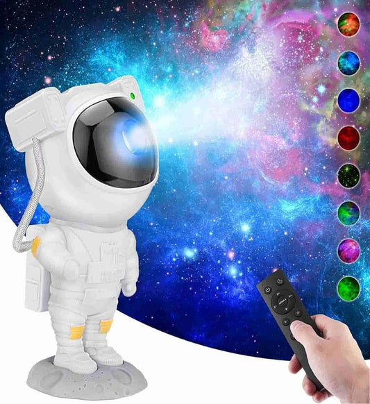 An astronaut-shaped galaxy projector emitting colorful light patterns, with a person holding a remote control in the foreground.
