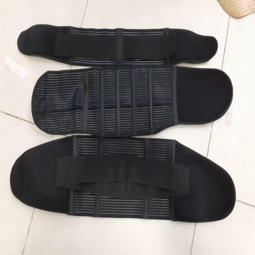 Three black protective pads arranged on a tiled floor.