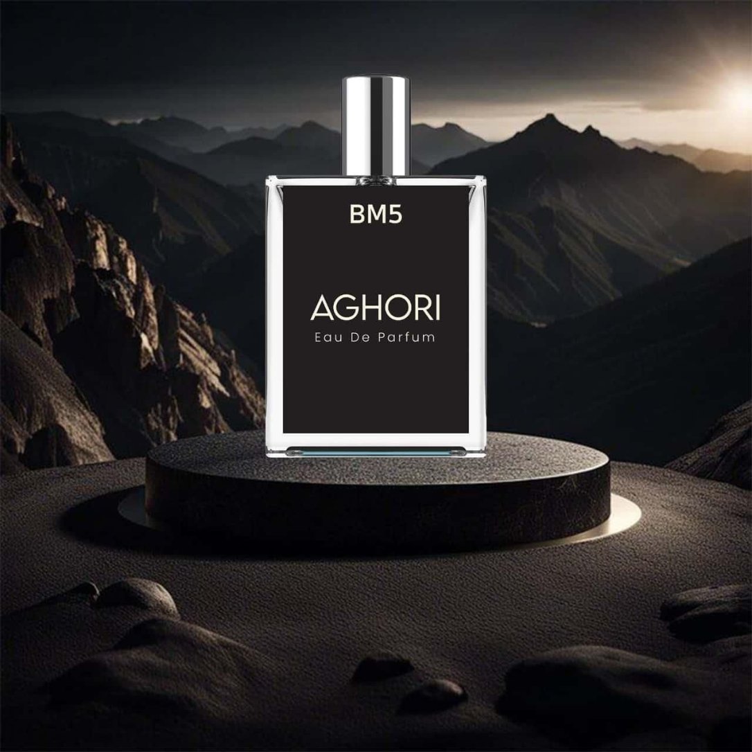 A bottle of AGHORI Eau De Parfum perfume placed on a pedestal with a mountainous backdrop.
