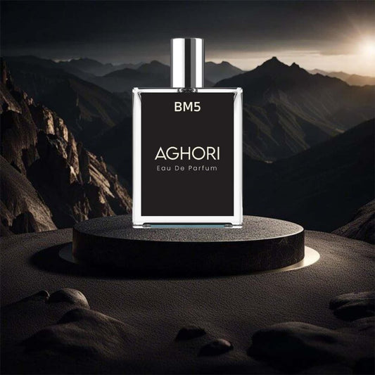 A bottle of AGHORI Eau De Parfum perfume placed on a pedestal with a mountainous backdrop.