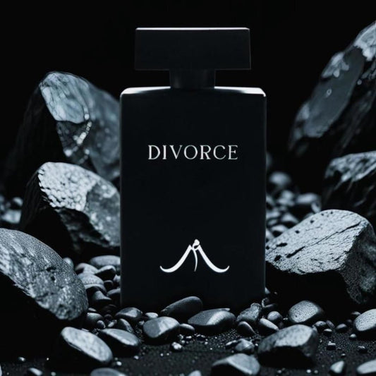 A black bottle of women's long-lasting perfume with the word 'DIVORCE' printed on it, surrounded by stones and rocks.