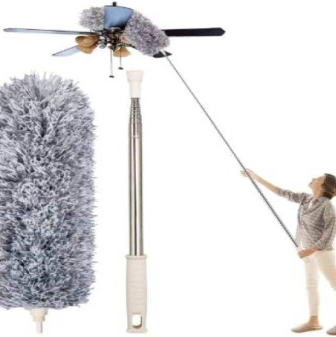 An extendable and bendable fan cleaning duster with a gray fluffy head and a long metal handle being used to clean a ceiling fan.