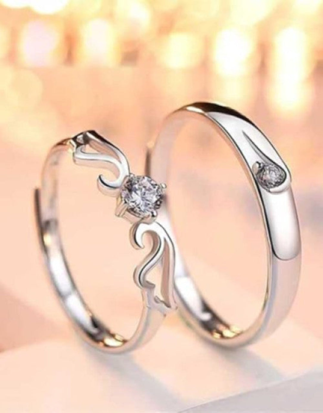 Silver ring with diamond accents on a blurred background
