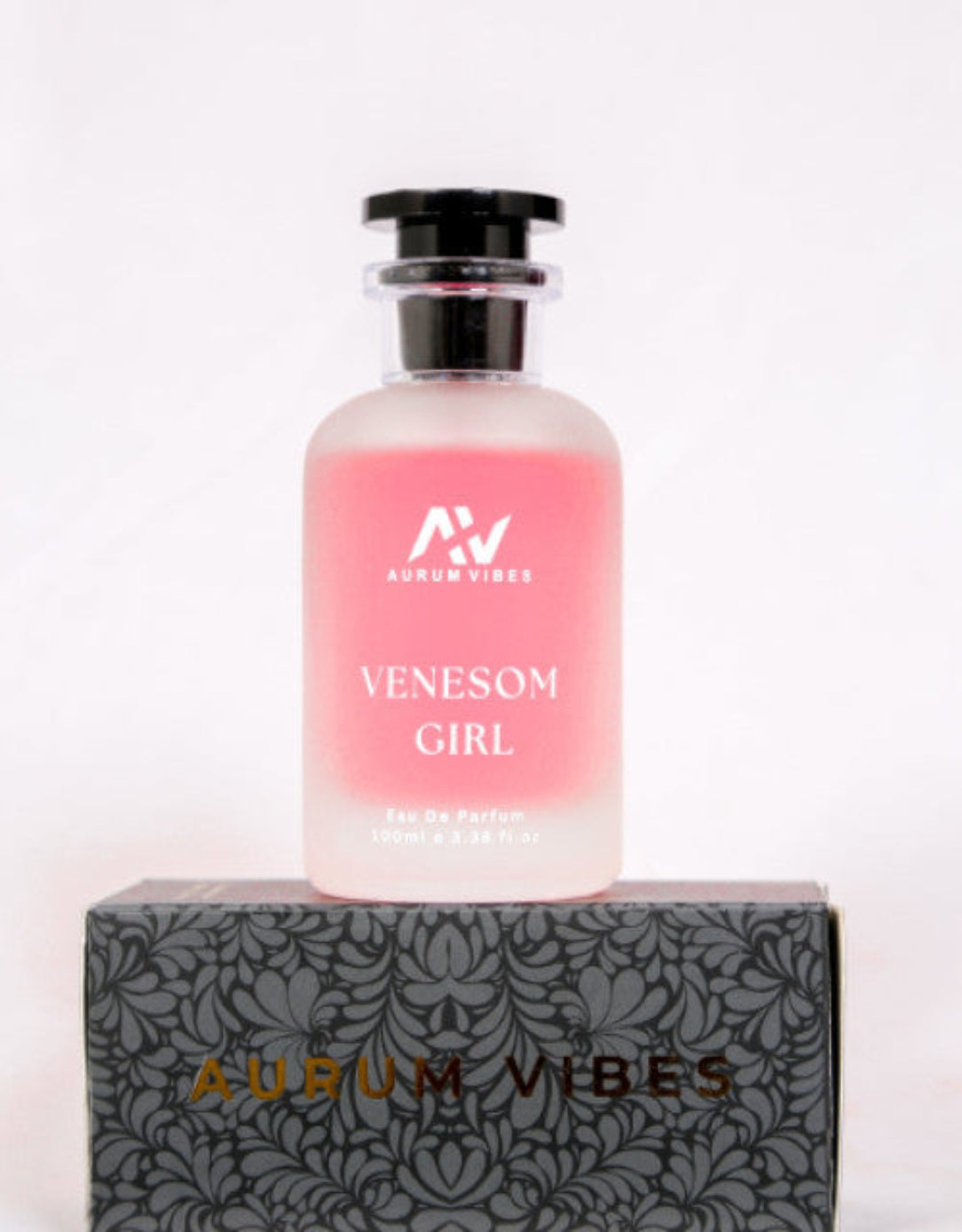 Pink perfume bottle labeled 'Venesom Girl' by 'Aurum Vibes' on a decorative box with the brand name.