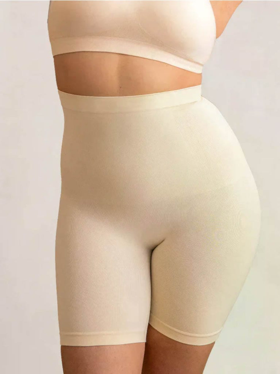 Beige shapewear shorts on a plain background