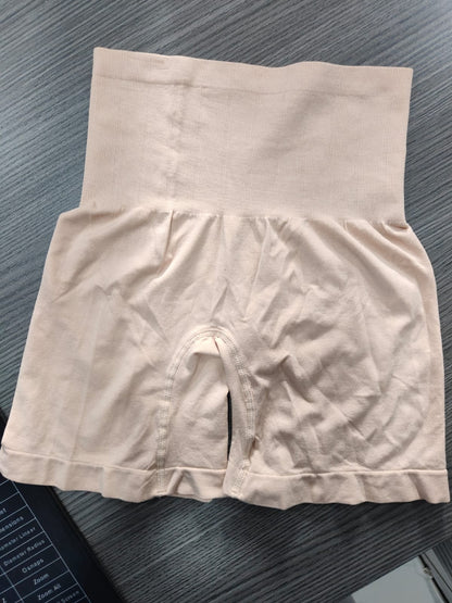 Beige high-waisted underwear on a dark textured surface