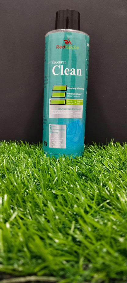 Bottle of 'Clean' cleaning solution on artificial grass with a black background