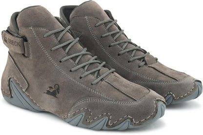 Pair of gray suede boots with laces on a white background