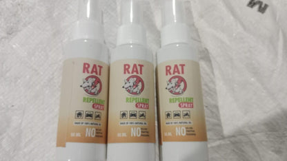 Three bottles of rat repellent spray on a textured white background