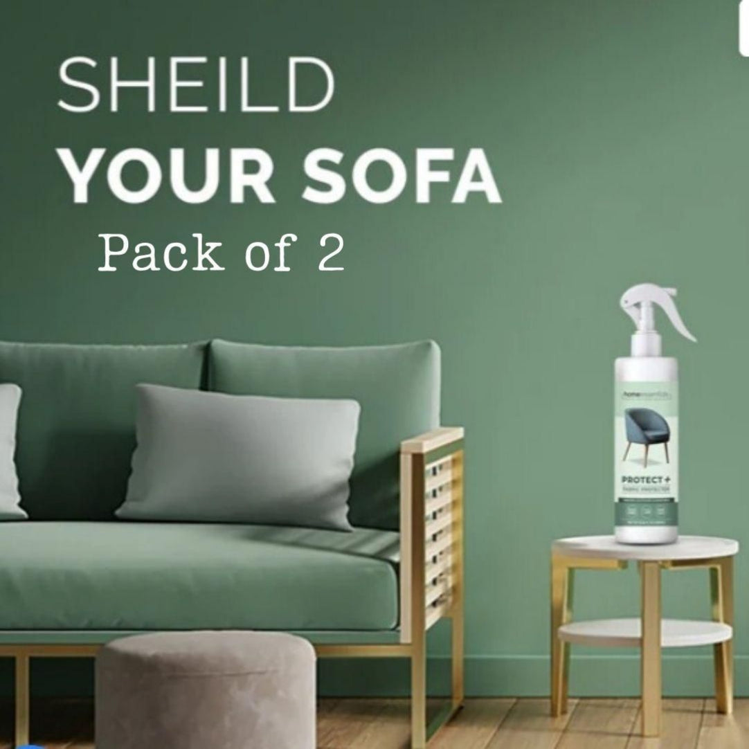 A bottle of Multipurpose Protect+ Fabric Protector is displayed in a home setting, with a sofa in the background and a pillow on the couch.