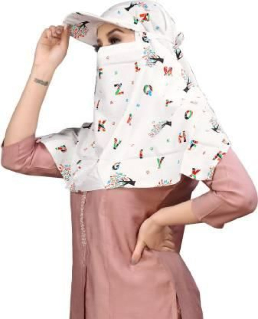 Woman wearing a patterned hijab and pink outfit on a white background