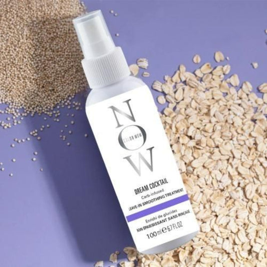 Skincare treatment bottle on a textured purple background with oats and seeds.