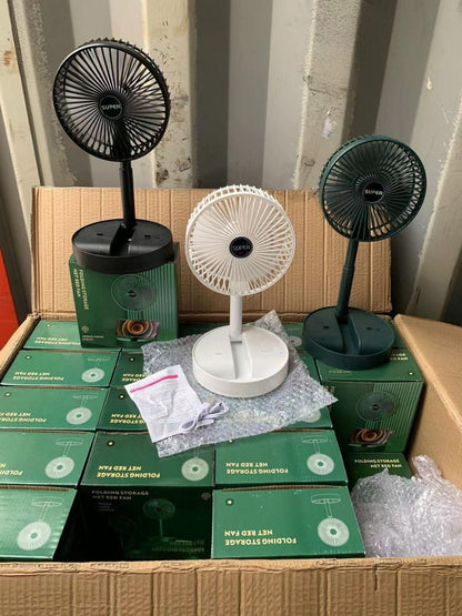 Tabletop fans and boxes on a cardboard surface with a striped wall background