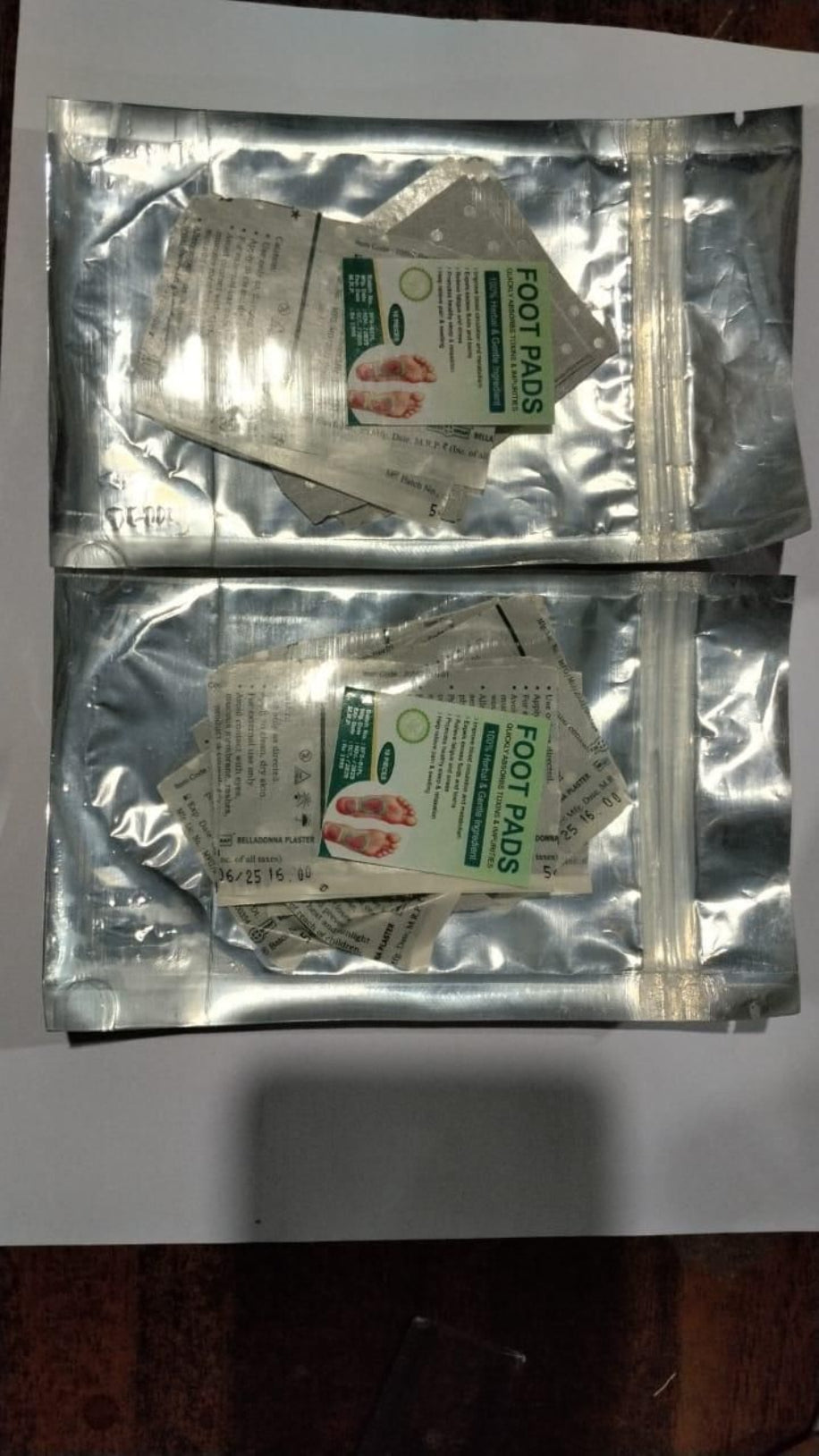 Two packages of foot pads on a white background