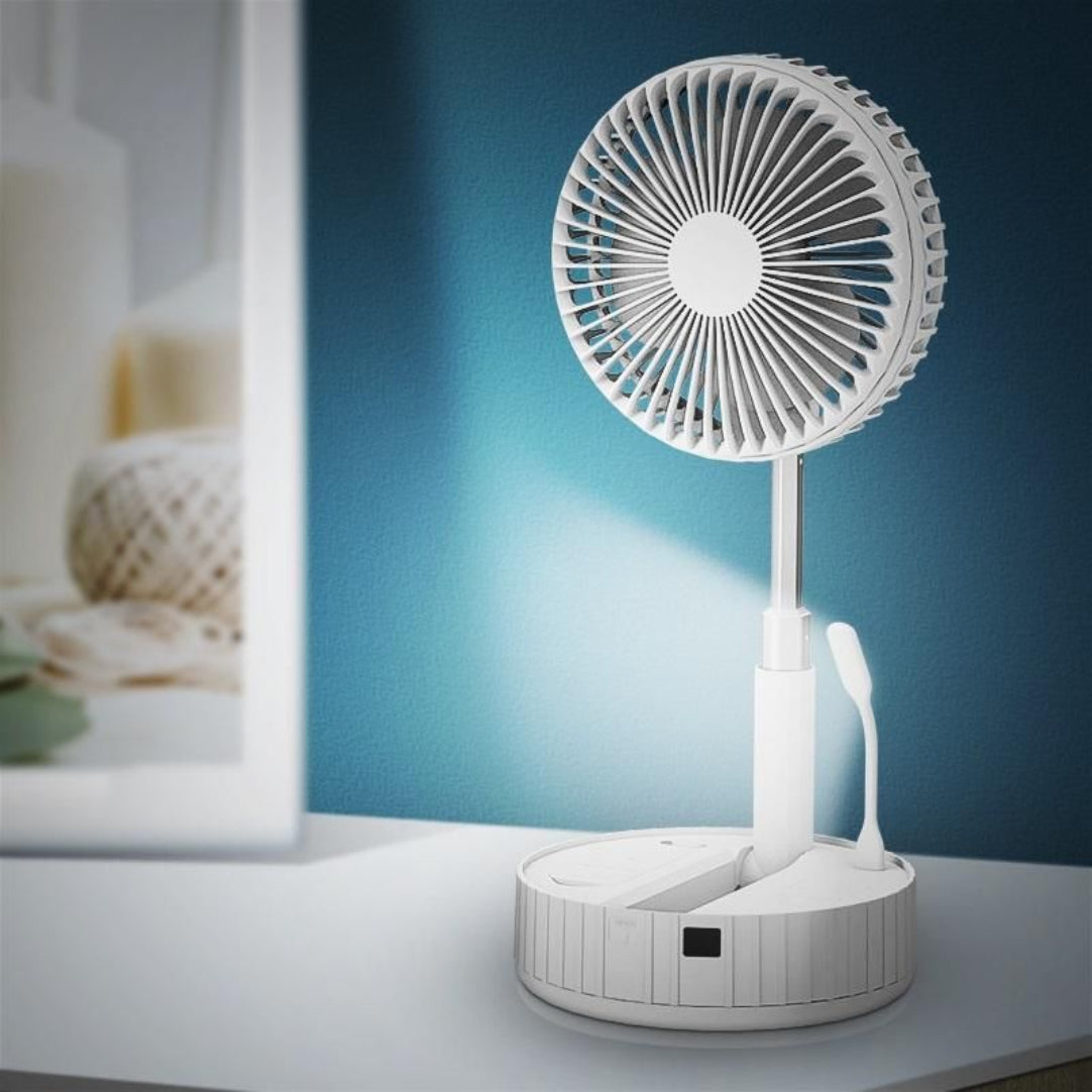 White desk fan on a white surface with a blue gradient background