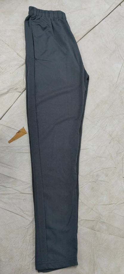 Dark gray pants on a light tiled floor
