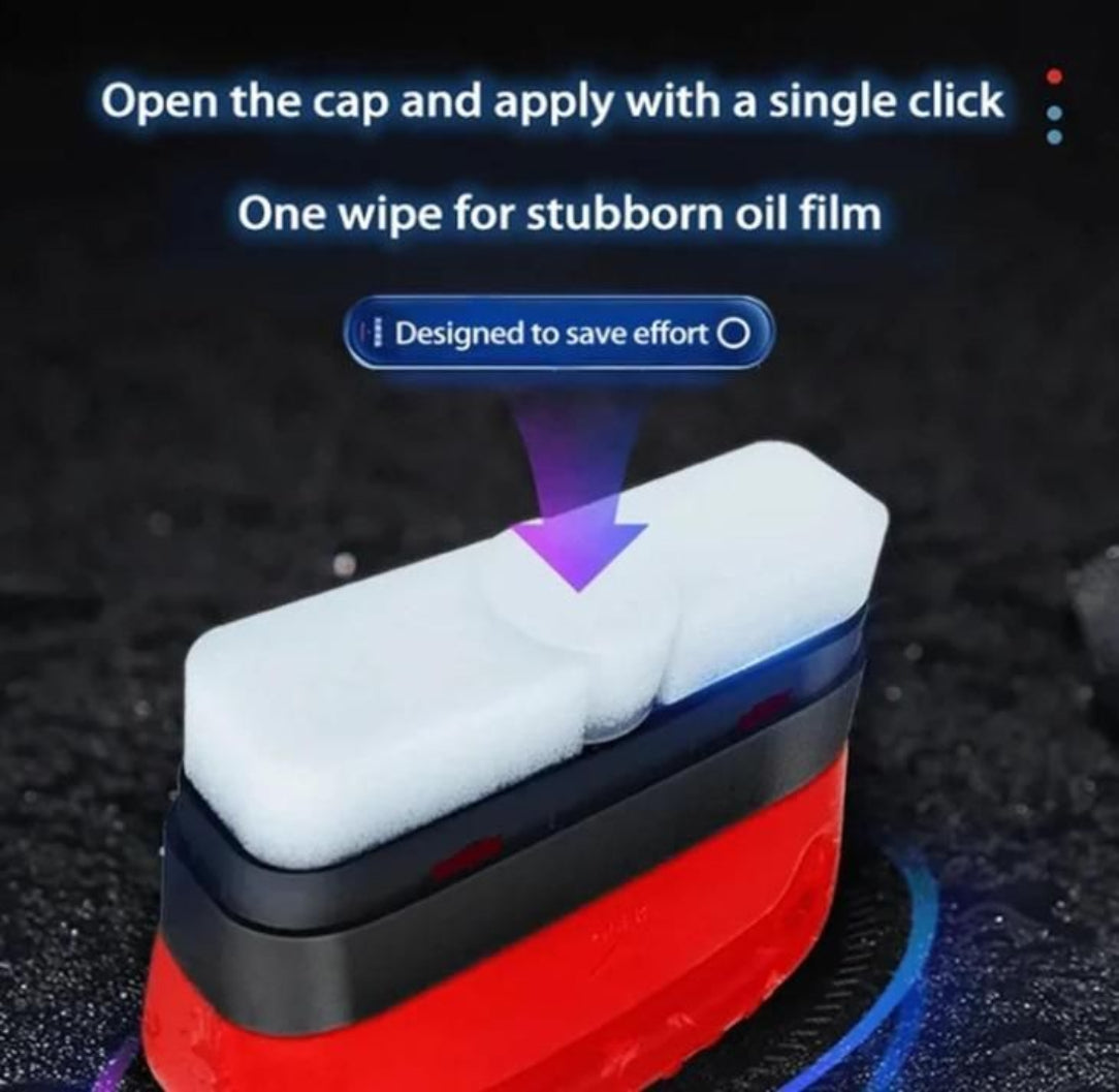 Red and black cleaning tool with a white foam pad on a dark background