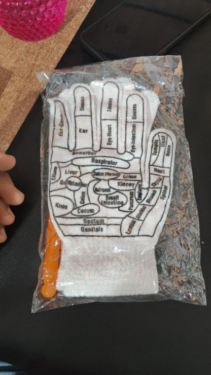 Plastic bag with a diagram of a hand and text, held by a hand against a dark background.
