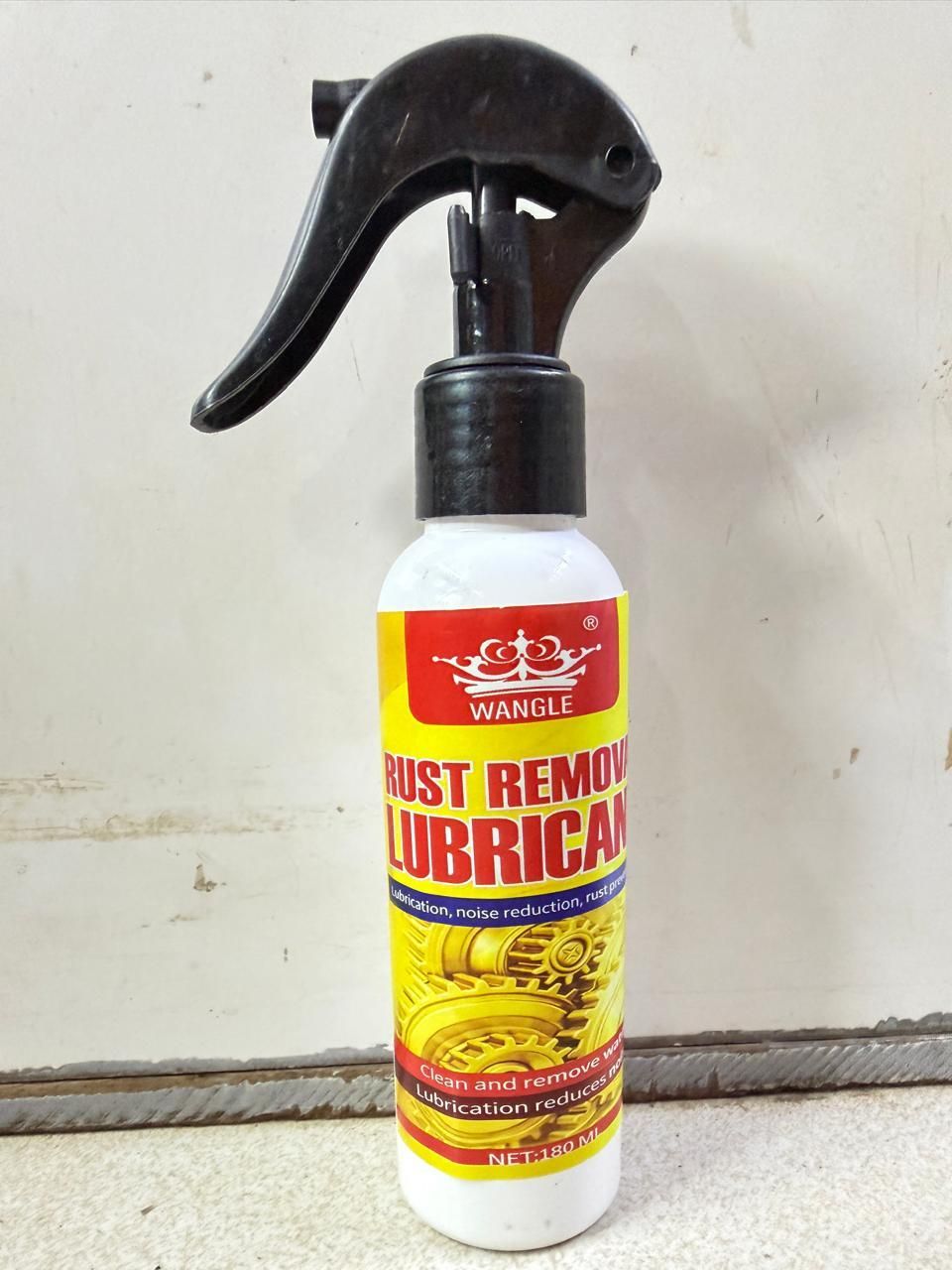 Spray bottle labeled 'Rust Remover Lubricant' on a textured surface