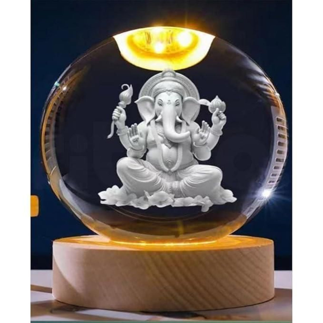 Crystal ball with Ganesha statue on a wooden base against a dark background