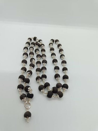 Necklace with black and silver beads on a white background
