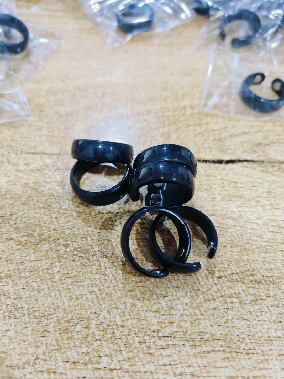 Black earplugs on a textured surface with packaging in the background