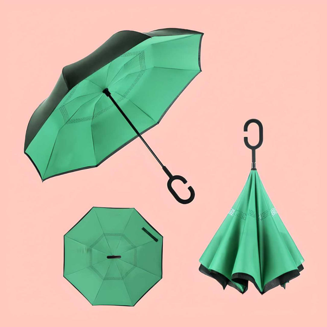 Green reverse umbrella shown from multiple angles on a pink background