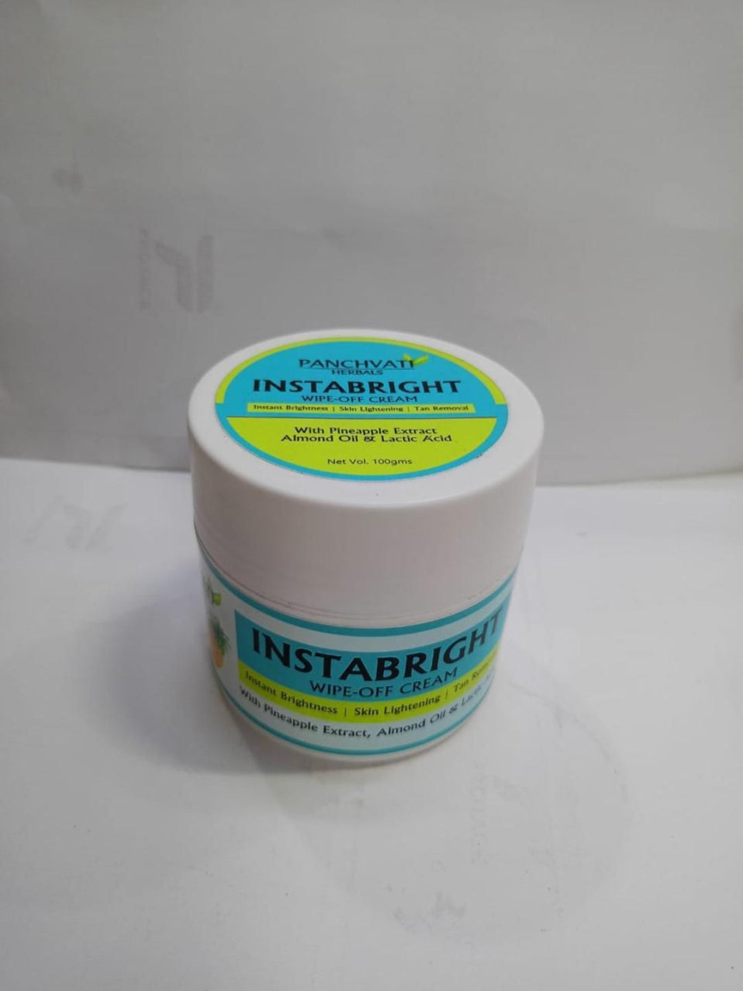 Jar of Instabright cream with a white background