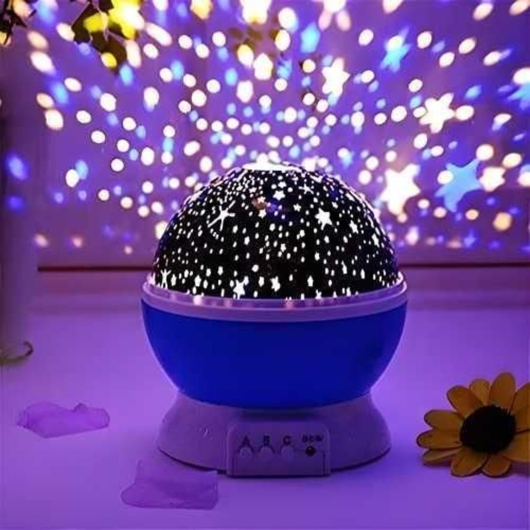 Starry night light projector with colorful light display in a room.