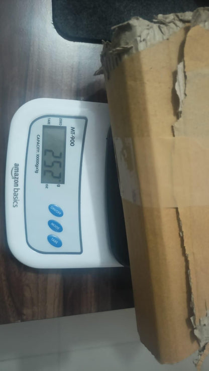 Digital scale displaying weight next to a cardboard box