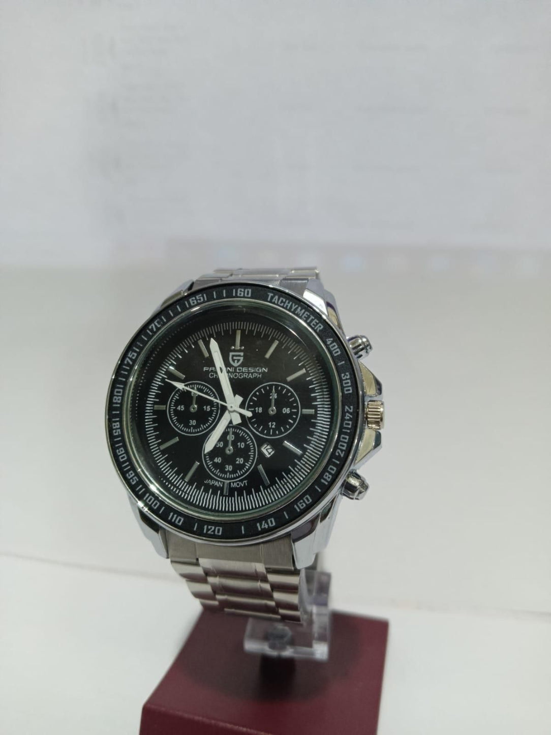 Silver watch with a black face on a white background