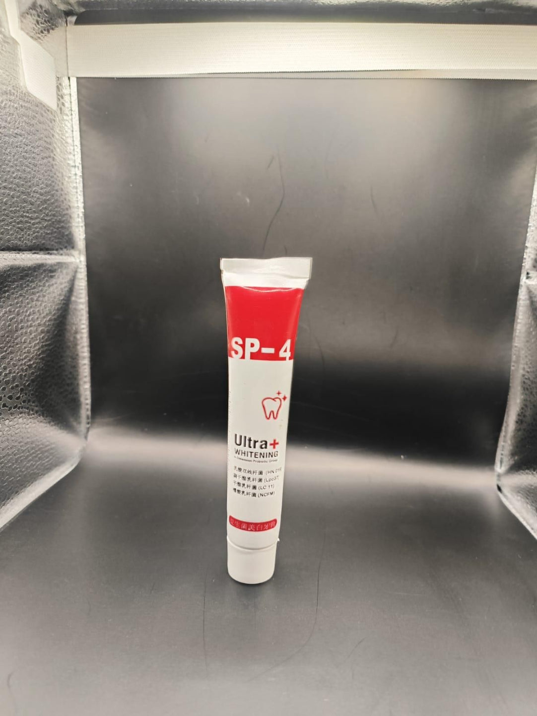 Tube of SP-4 Ultra+ adhesive on a metallic surface