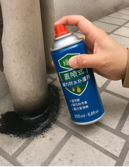 Hand holding a blue spray can with red nozzle near a black substance on a concrete surface.