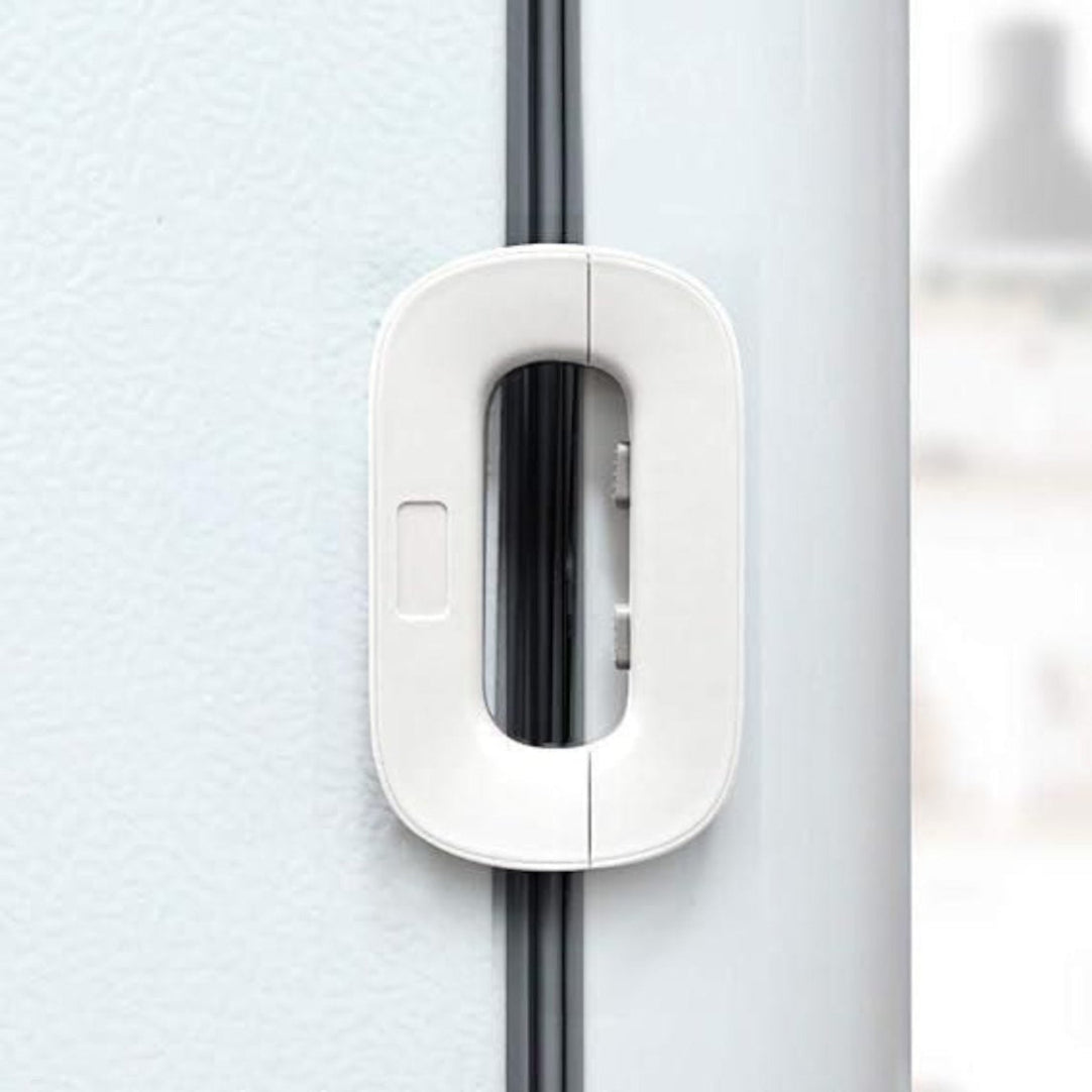 White door handle on a gray door with a blurred background