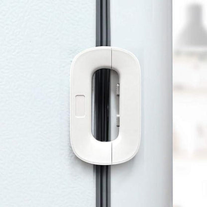 White door handle on a gray door with a blurred background