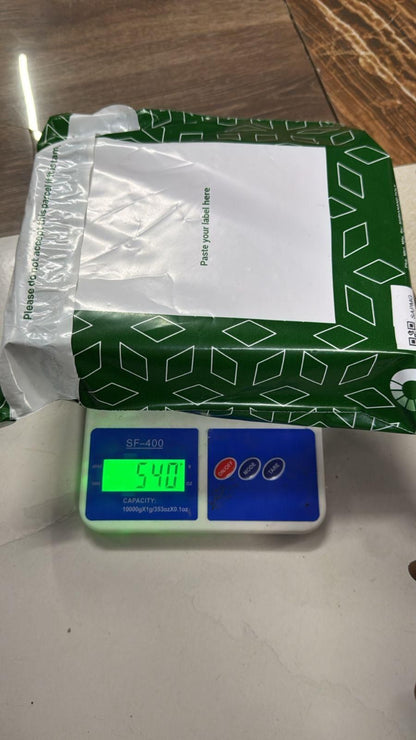 Green box with a white label on a digital scale displaying weight