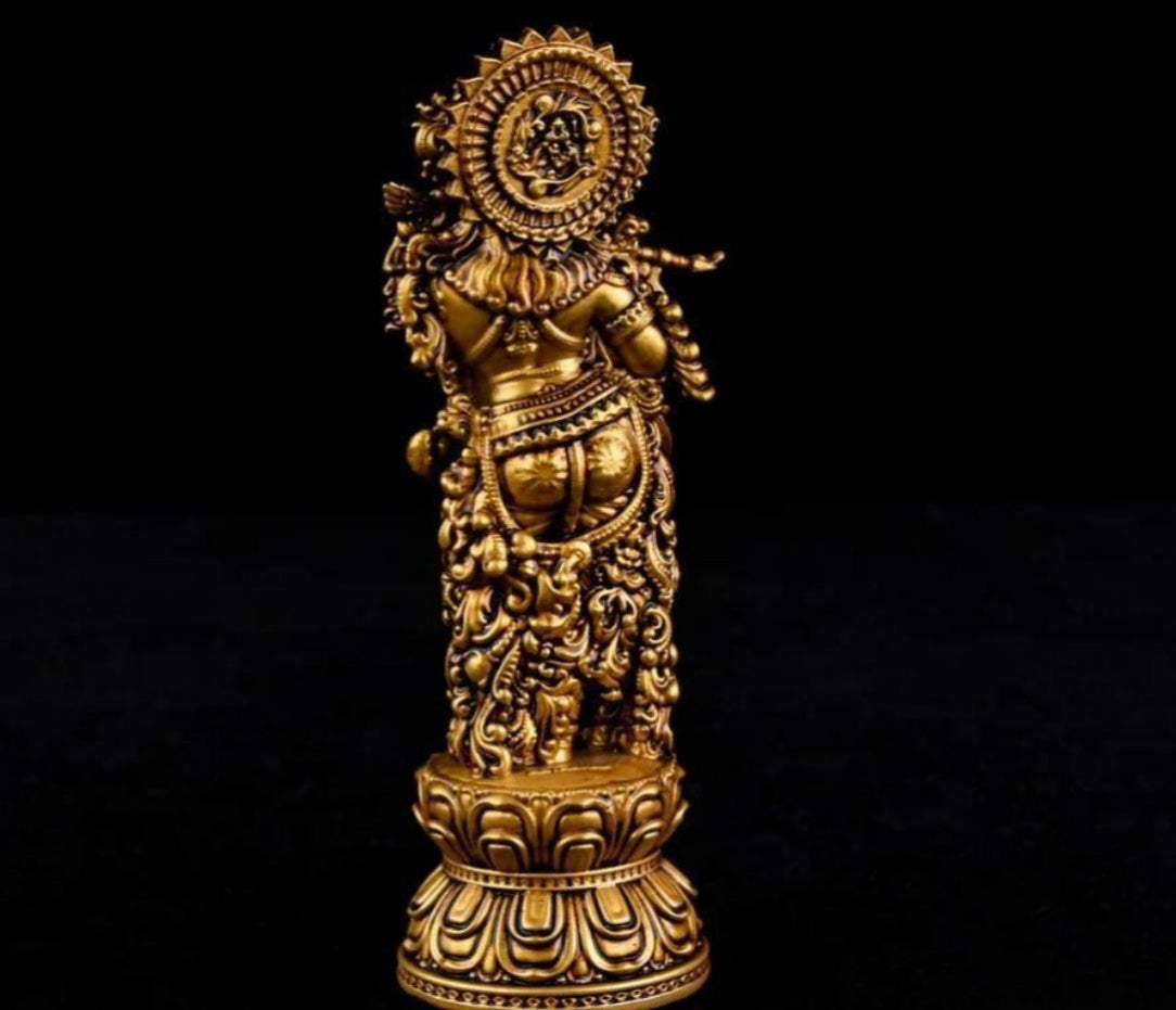 Decorative gold figurine on a black background
