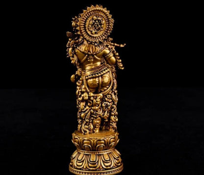 Decorative gold figurine on a black background