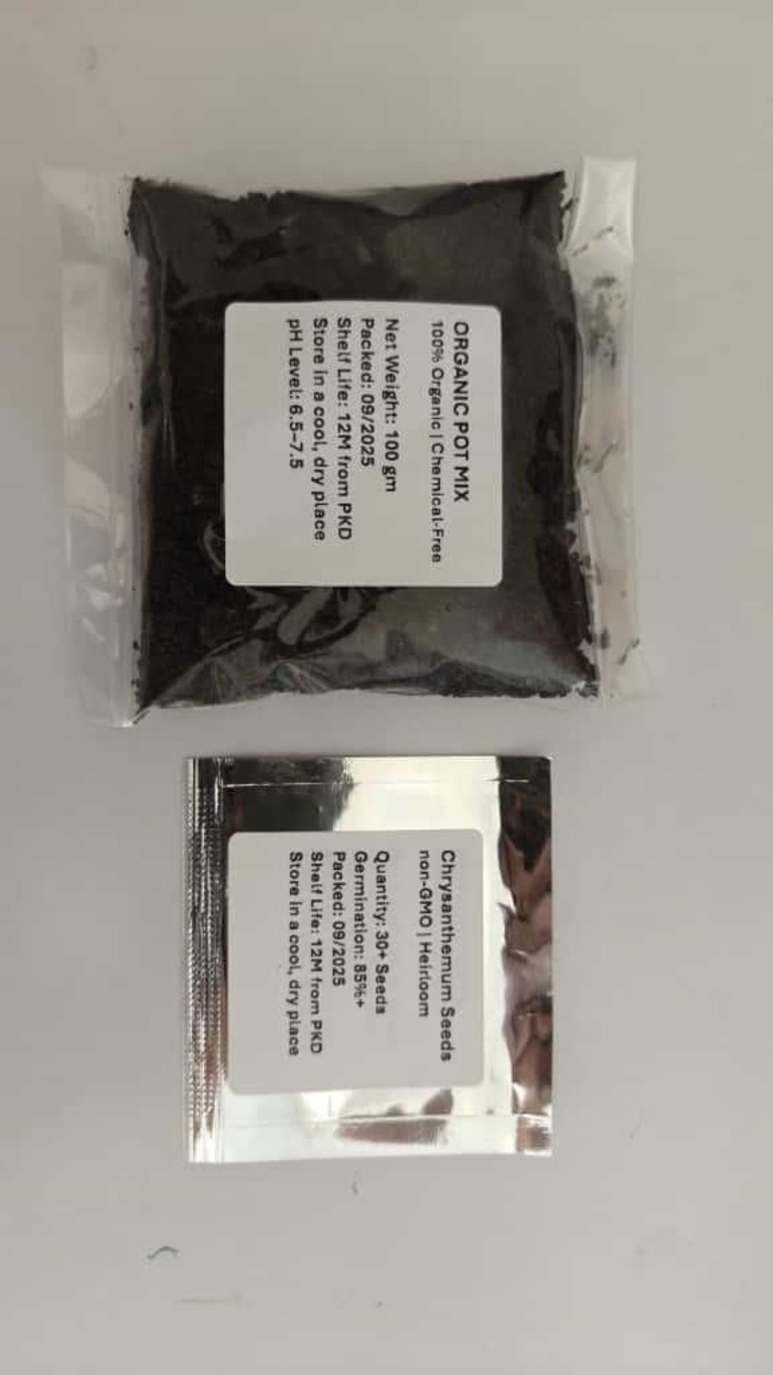 Two packages of black seeds with labels on a gray background