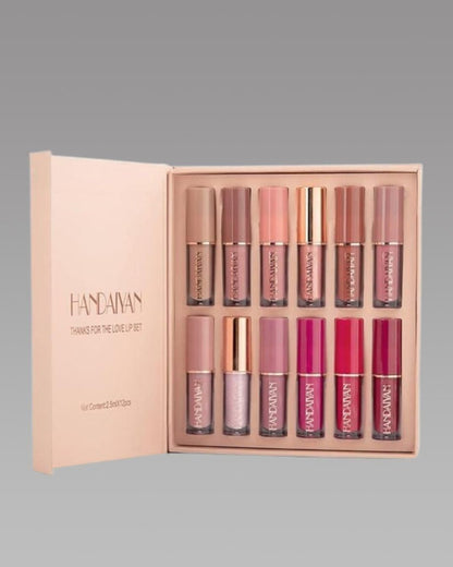 Set of lip glosses in a display case with 'Handaway' branding.