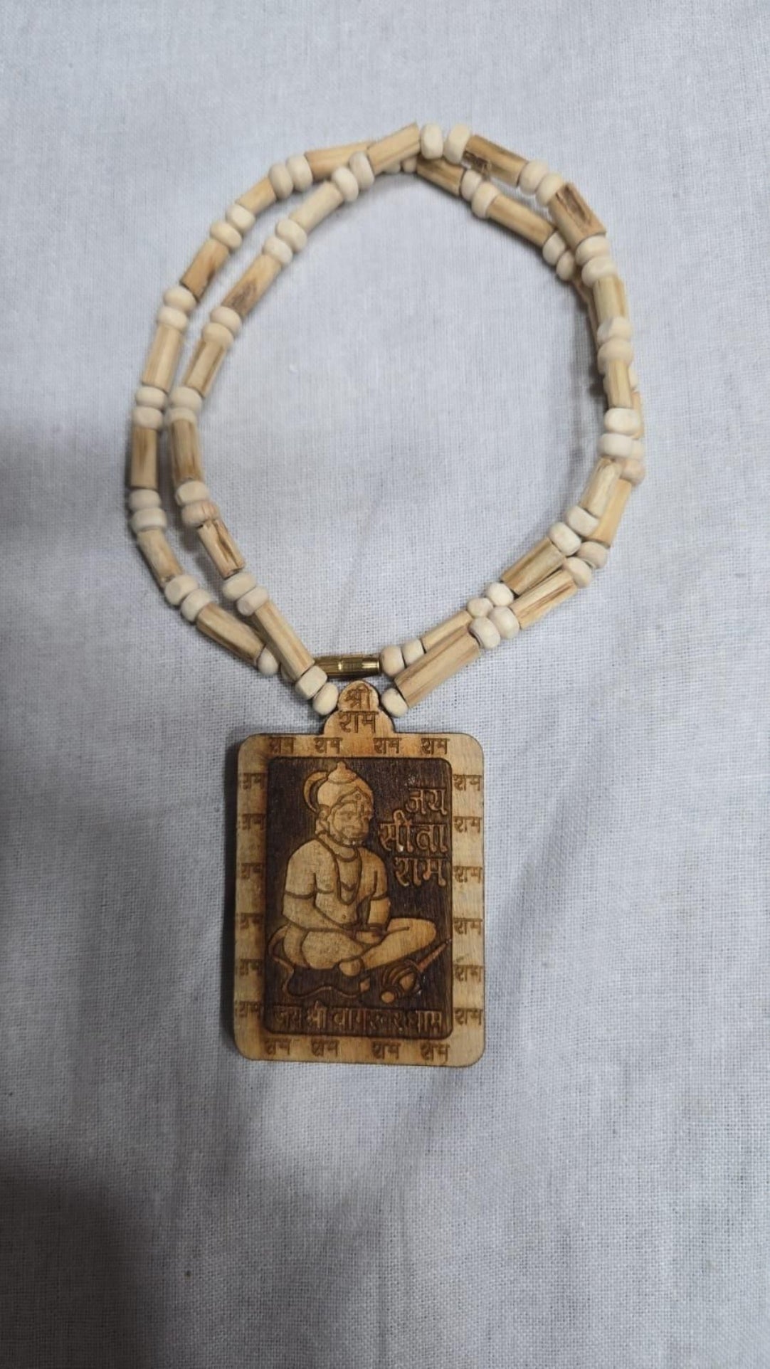 Necklace with a pendant featuring an engraved image on a gray background