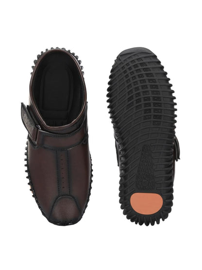 Brown shoe with black sole on a white background