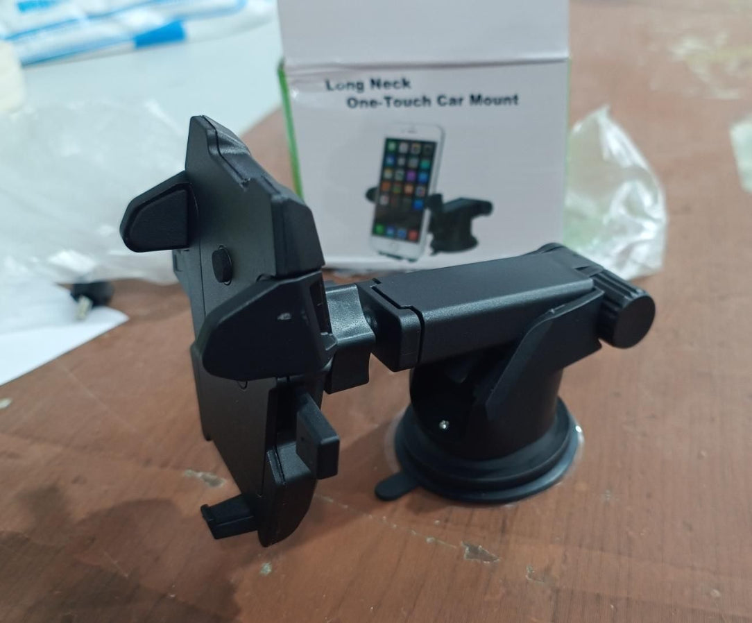 Black car phone mount with packaging on a cardboard surface