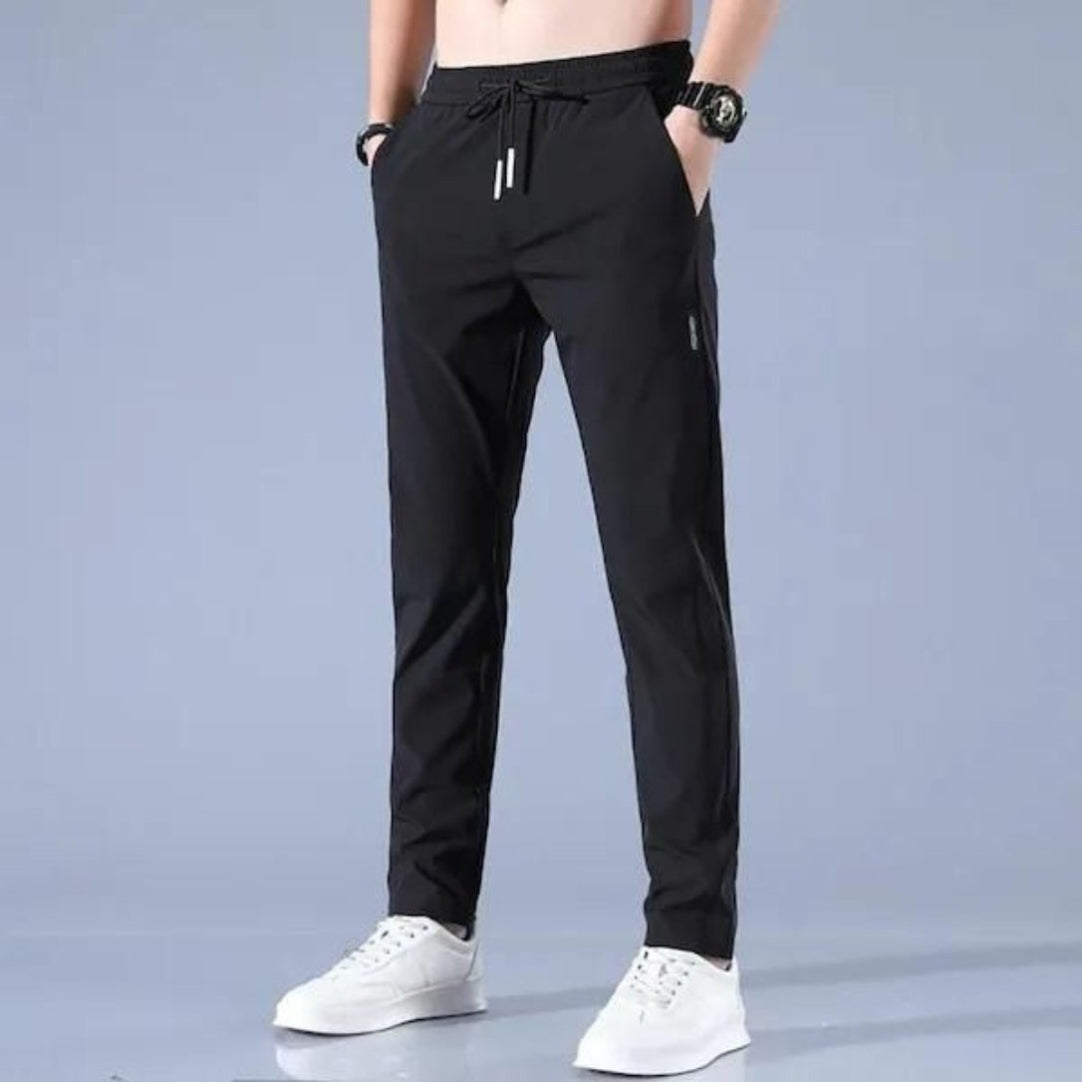 Black pants worn by a person on a gray background