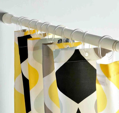 Curtains with geometric pattern hanging on a rod against a white background